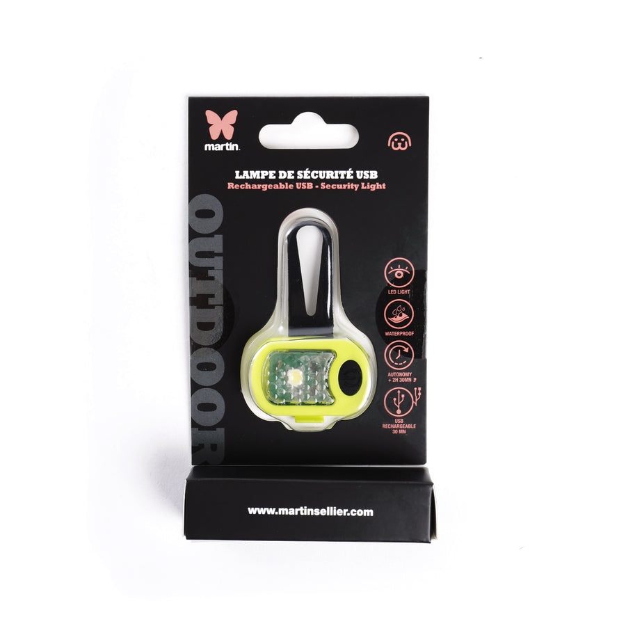 Lámpara de seguridad LED para perros en color verde, presentada en su packaging original de Martin Sellier. Accesorio recargable por USB, impermeable y con clip para collar o correa. Ideal para paseos nocturnos y máxima visibilidad.