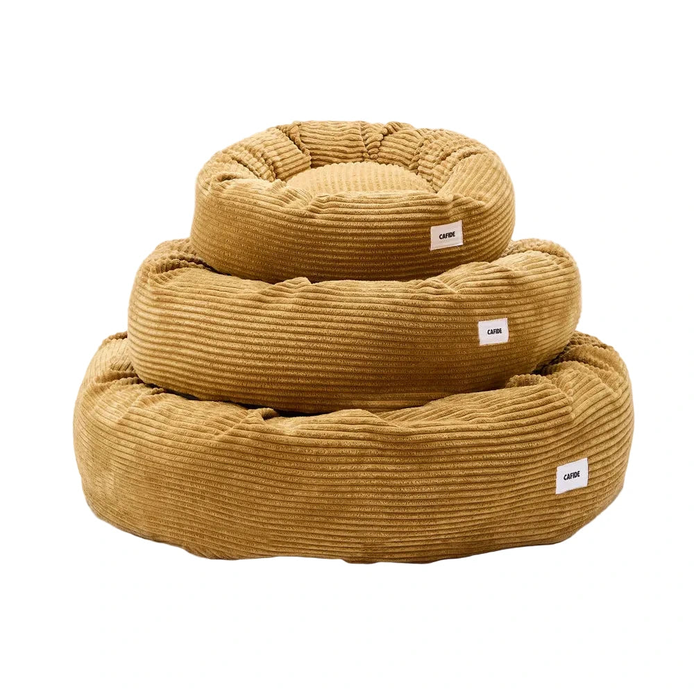 Cama para perro Nuba mostaza de CAFIDE en diferentes tamaños con diseño redondo y acolchado suave