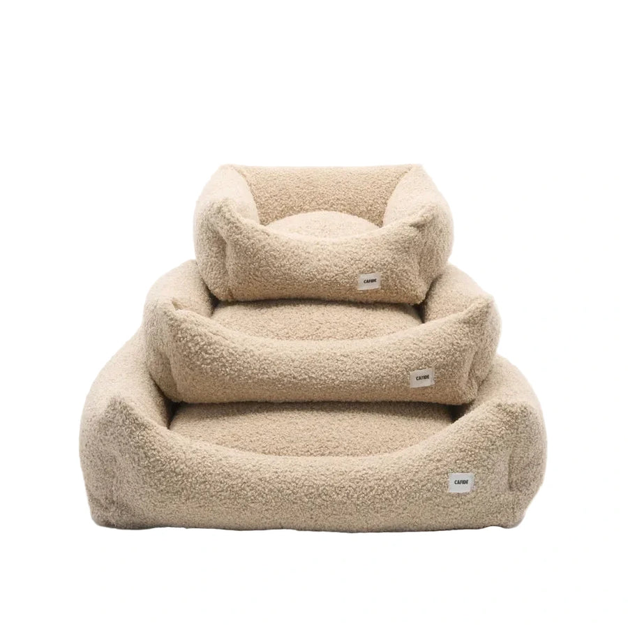 Cama para perro Snozy CAFIDE color beige con tejido efecto borreguito suave y bordes elevados