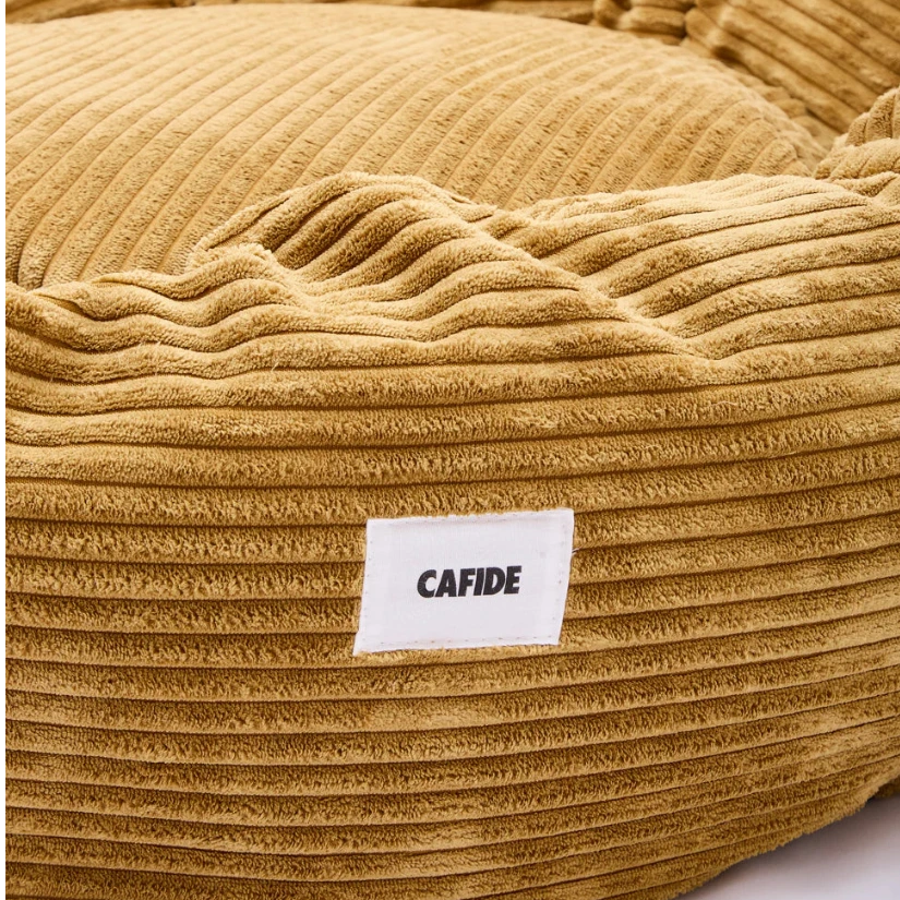 Detalle del tejido suave y textura de la cama para perro Nuba color mostaza de CAFIDE